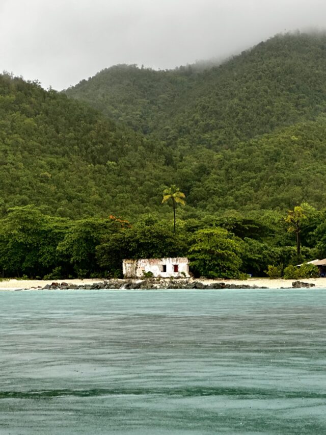 driving by boat past the beach ruins in the Virgin Islands National park with Rocknrolla st john boat charters.jpg