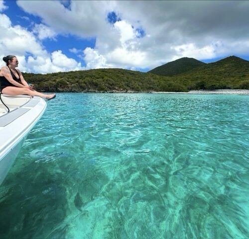 Turquoise water off St John seen from the bow of a RocknRolla private boat charter