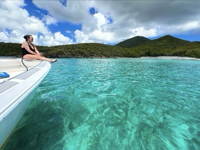Turquoise water off St John seen from the bow of a RocknRolla private boat charter